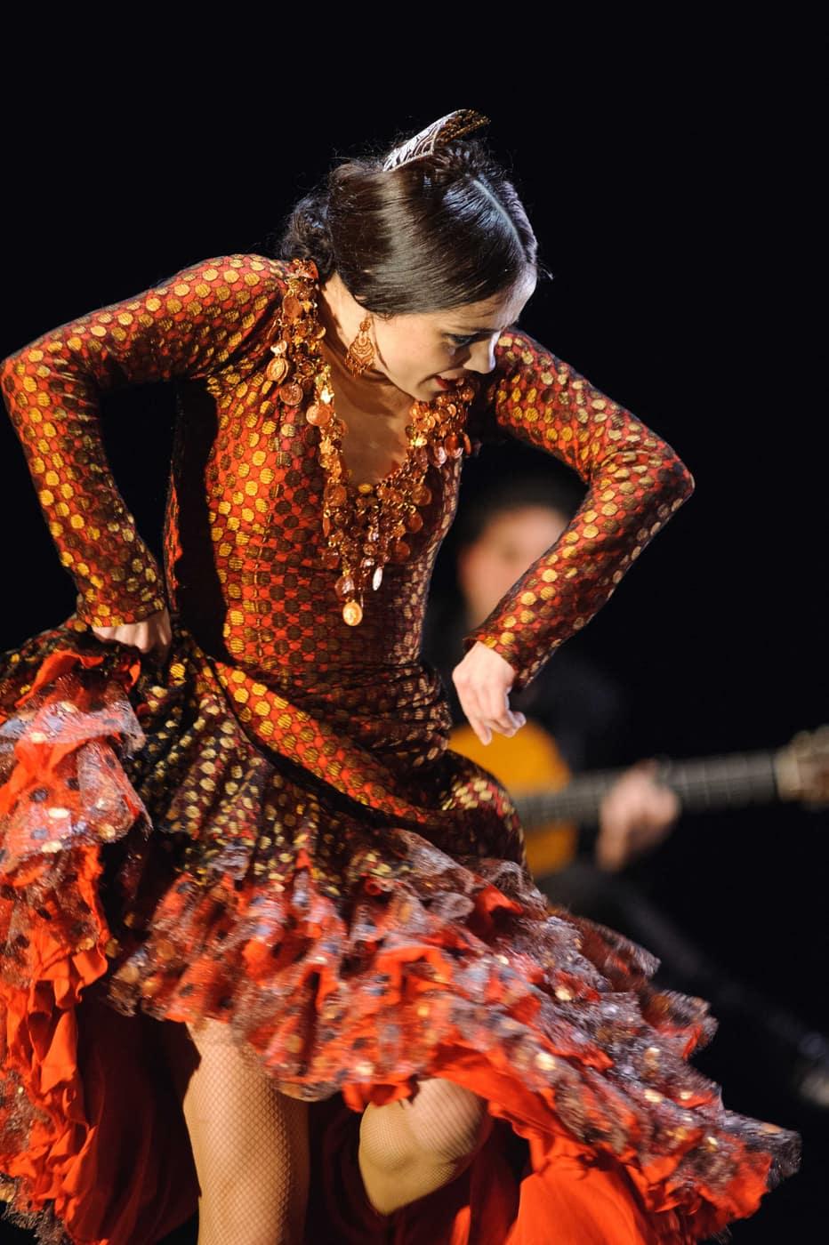 Flamenco dancer in a sunlit Andalusian courtyard