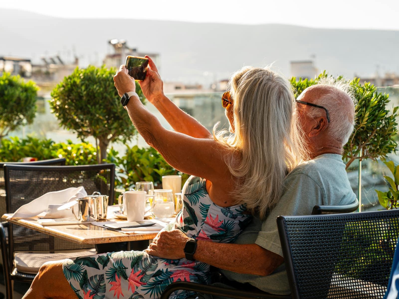 Older couple savouring the view from a sunny Andalusian terrace